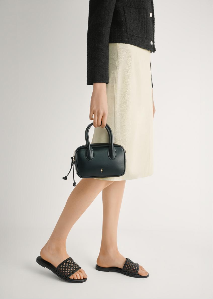 Women's black braided flip-flops BUTYD-1253-99(W26), side view of the product on the model's feet.