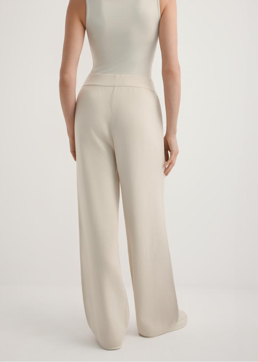 Beige women's wide leg trousers SPODT-0121-1A(W26), back view of the product on the model. Half of the silhouette visible.