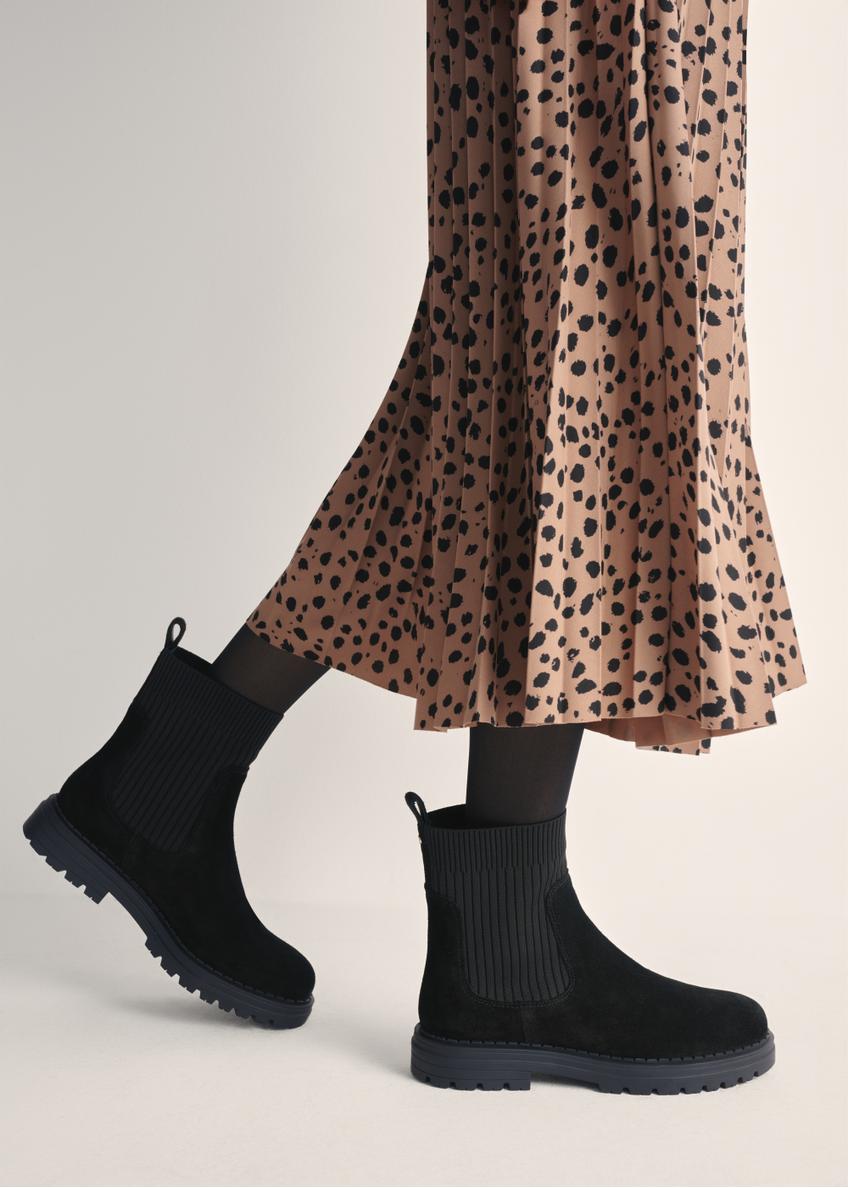 Women's black suede Chelsea boots BUTYD-1194-99(Z25) - side view of the product on a model against a white background. Half of the silhouette visible.