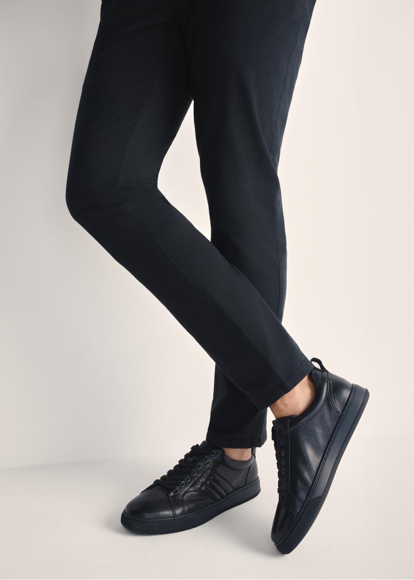 Black men's leather sneakers BUTYM-0465-99(Z25), product view on model's feet against a light background.
