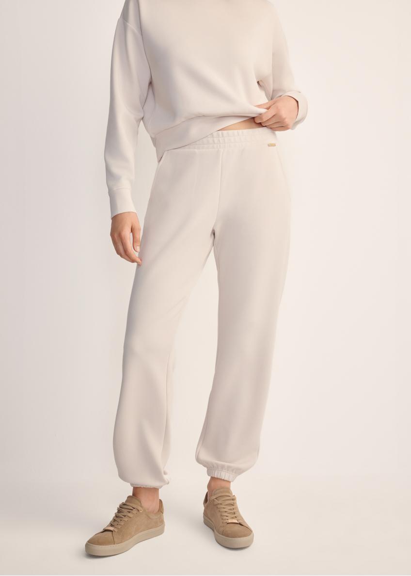 Light beige women's trousers SPODT-0117-80(Z25), front view of the product on the model. Half of the silhouette visible.
