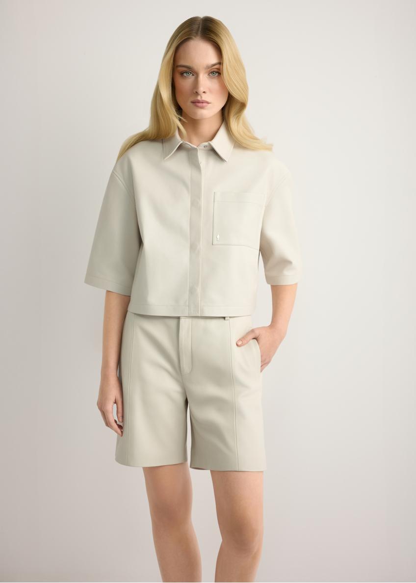 Women's cream leather shorts SPODS-0047-0B(W26), front view of the product on the model. Half of the silhouette visible.