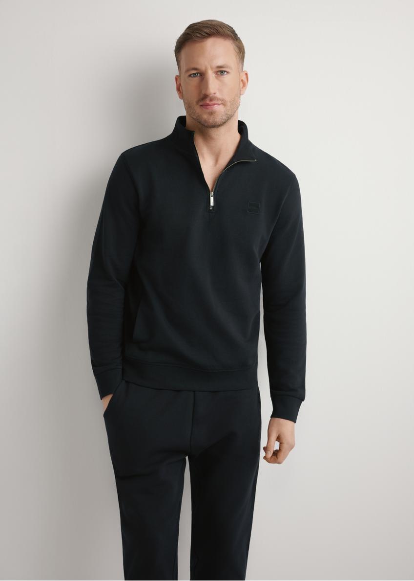 Black men's sweatshirt with stand-up collar BLZMT-0080-99(W26) - front view of the product, on a model, on a light background.