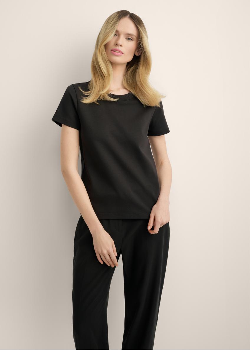 Women's black cotton t-shirt TSHDT-0144-99(Z25), front view of the product on the model. Half of the silhouette visible.