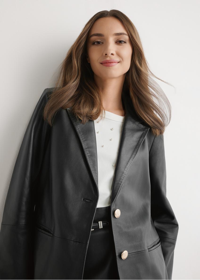 Women's black leather jacket KURDS-0606-99(W26) - front view of the product, on a model, against a light background. Half of the silhouette visible.