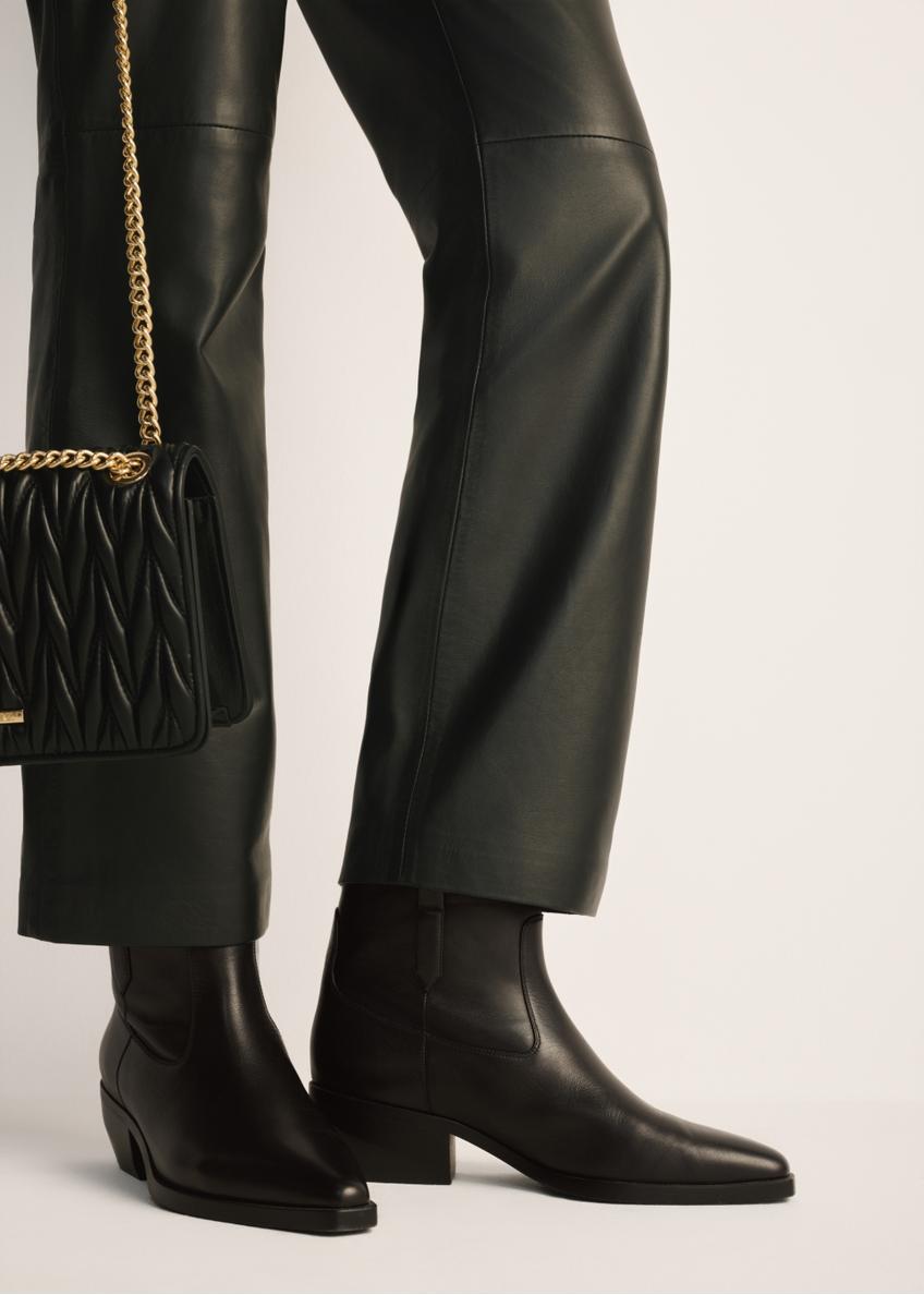 Women's leather ankle boots BUTYD-1209-99(Z25), product view on the model's feet against a light background.
