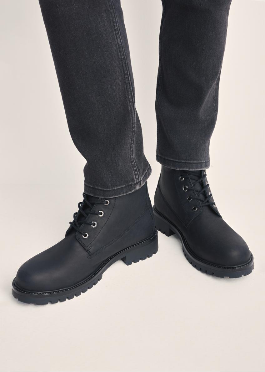 Black leather lace-up men's ankle boots BUTYM-0514-99(Z25) - front product view on model against white background. Close-up.
